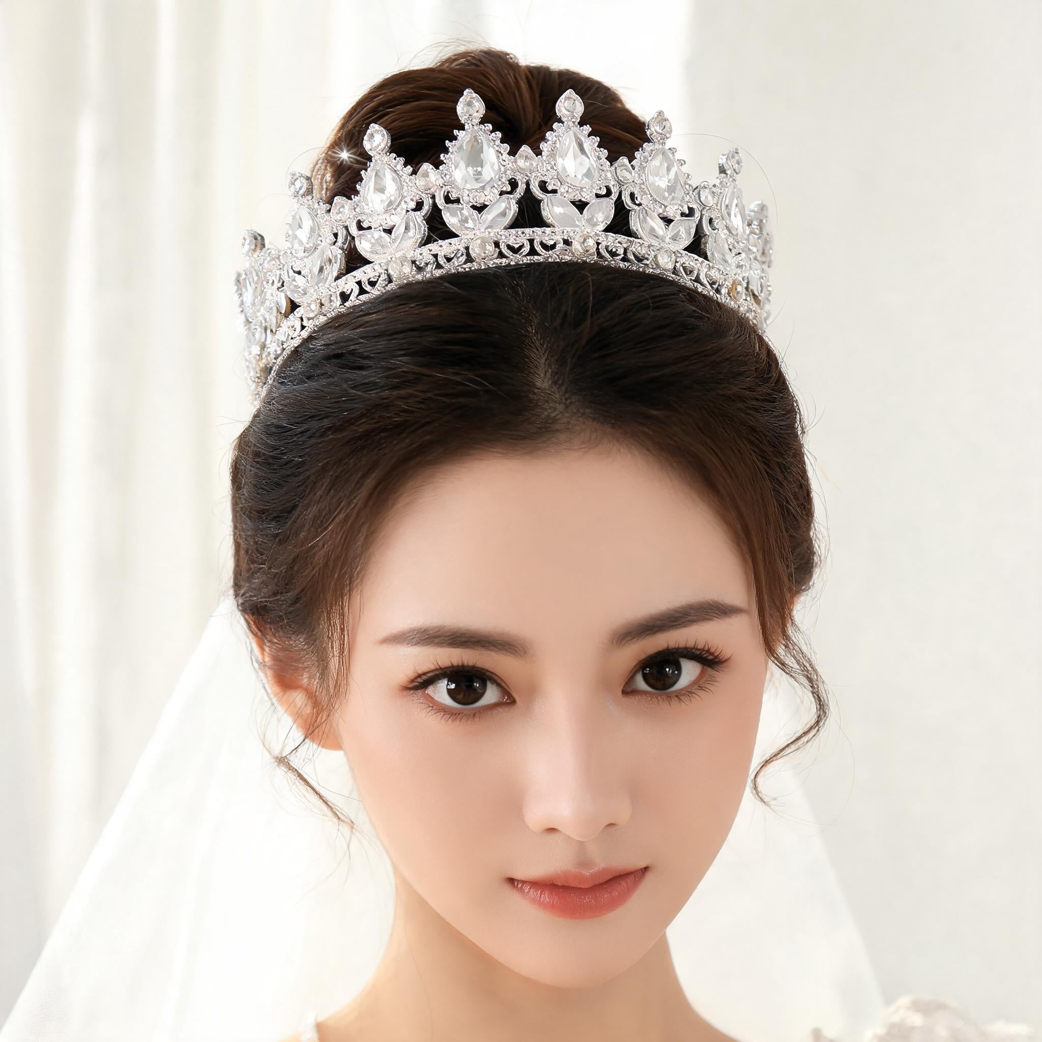 Crystal tiara worn by a bride in a bright bridal suite